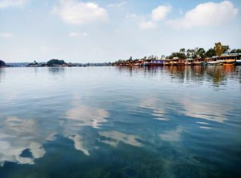 Calm lake against cloudy sky