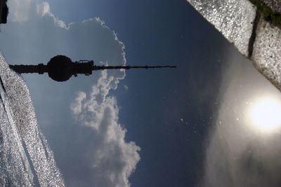 Reflection of fernsehturm and sky in puddle