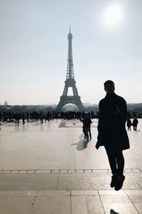 Man levitating against tourists and eiffel tower
