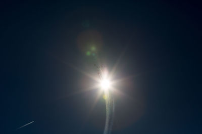 Low angle view of sun shining in blue sky