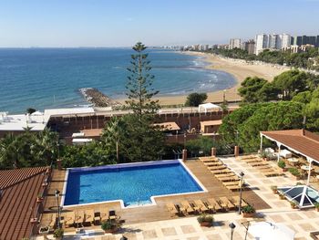 High angle view of swimming pool by sea against clear sky