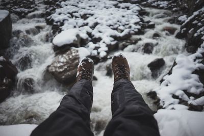 Low section of man over frozen river