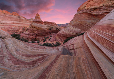 Scenic view of rock formations against cloudy sky sunrise 