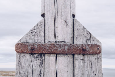 Close-up of wooden built structure against sky