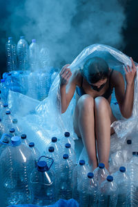 Woman protecting herself from plastic format. concept of recycling plastic and ecology.