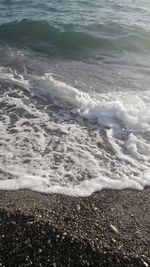 High angle view of waves rushing towards shore