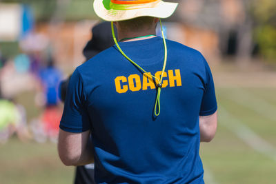 Rear view of coach standing at playing field