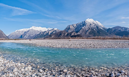 Scenic view of snowcapped mountains against blue sky