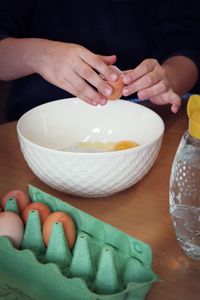 Hands of children baking cake