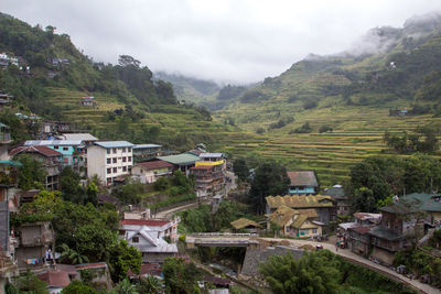 High angle view of houses and buildings against sky