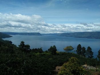 Scenic view of sea and mountains against sky