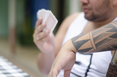 Midsection of man using mobile phone