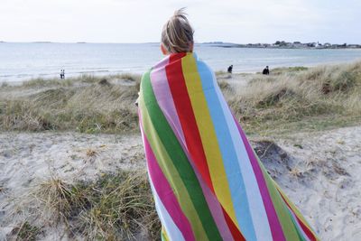 Rear view of woman standing on beach