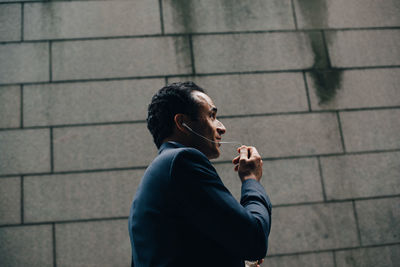 Side view of man smoking cigarette