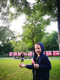 Optical illusion of smiling boy holing sister