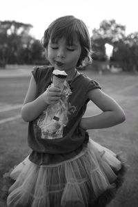 Girl eating ice cream on street