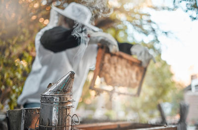 Low angle view of man holding metal