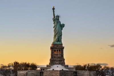 Statue of liberty against sky during sunset