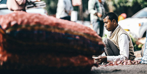 Side view of man sitting in temple