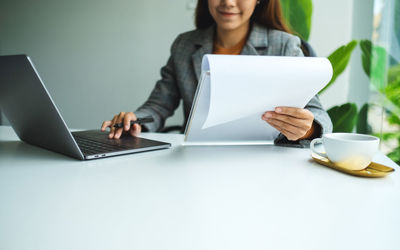 Closeup image of a businesswoman using laptop computer while working in office