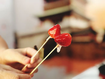 Close-up of hand holding strawberry