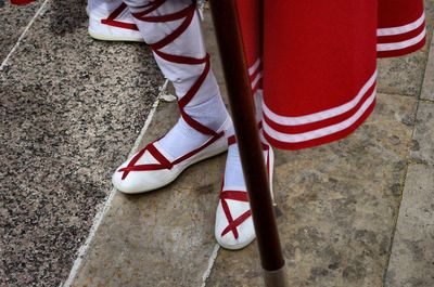 Low section of security guards in traditional clothes on footpath