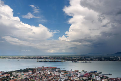 High angle view of townscape by sea against sky