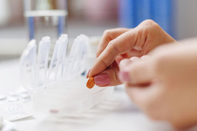 Cropped hand of scientist examining chemical in laboratory