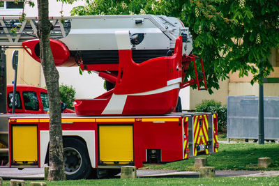 View of red cart and trees in park