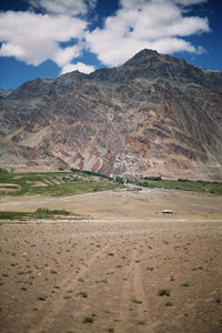 Scenic view of mountains against cloudy sky