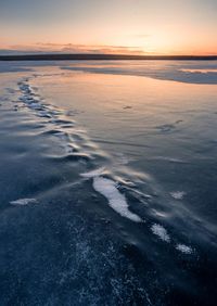 Scenic view of beach against sky during sunset