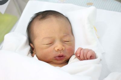 Cute baby sleeping in bed