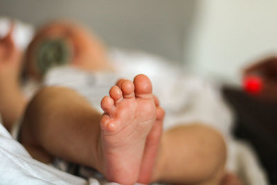 Baby boy lying on bed