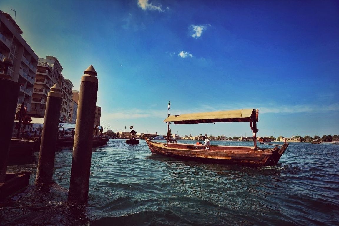 nautical vessel, water, boat, sea, moored, transportation, mode of transport, sky, blue, waterfront, built structure, harbor, sunlight, nature, day, outdoors, pier, architecture, travel, tranquility