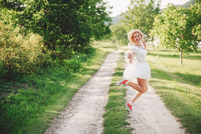 Full length of woman running on plants