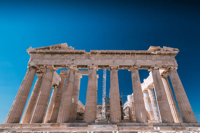 Low angle view of historical building against blue sky