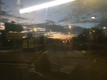 Illuminated street seen through wet glass window