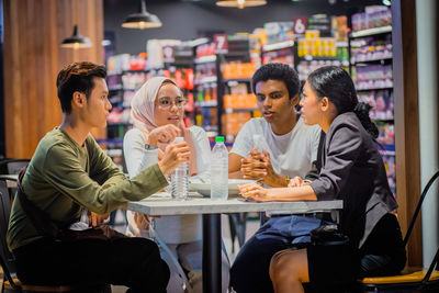 Friends sitting on table