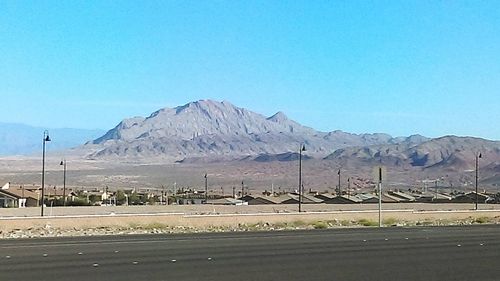 Scenic view of mountains against blue sky