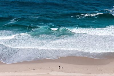 High angle view of sunny beach against ocean