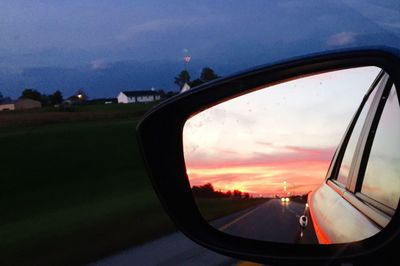 Reflection of sky on side-view mirror