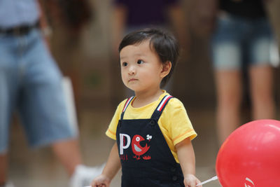 Portrait of cute boy standing outdoors