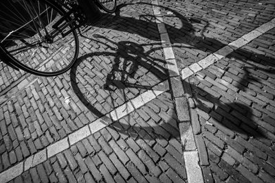 Shadow of bicycle on footpath