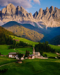 Scenic view of field and mountains against sky