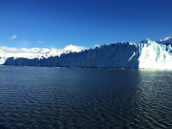 Scenic view of sea and snowcapped mountains during winter