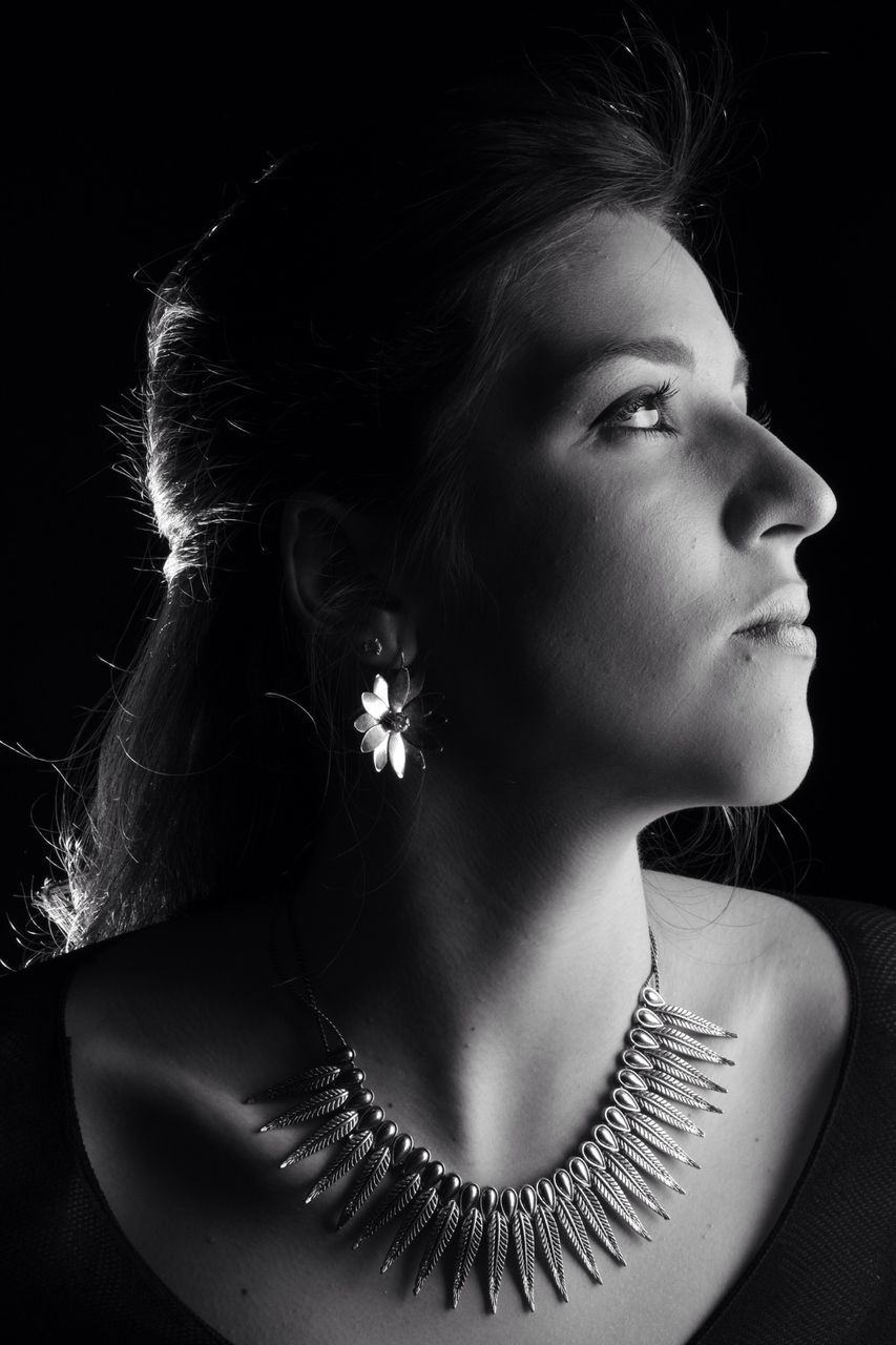 indoors, studio shot, black background, close-up, lifestyles, headshot, leisure activity, human face, young adult, young women, front view, holding, person, home interior, still life, high angle view