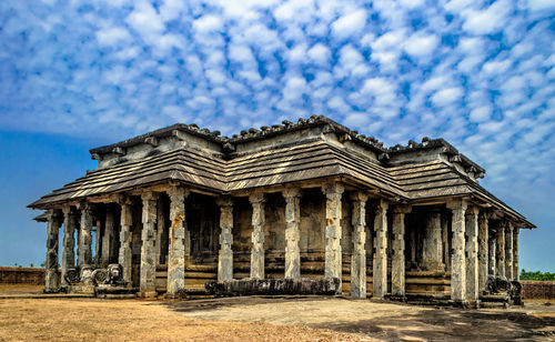 View of abandoned building against cloudy sky
