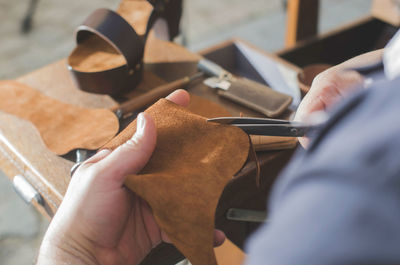 Close-up of shoemaker making sandal at workshop