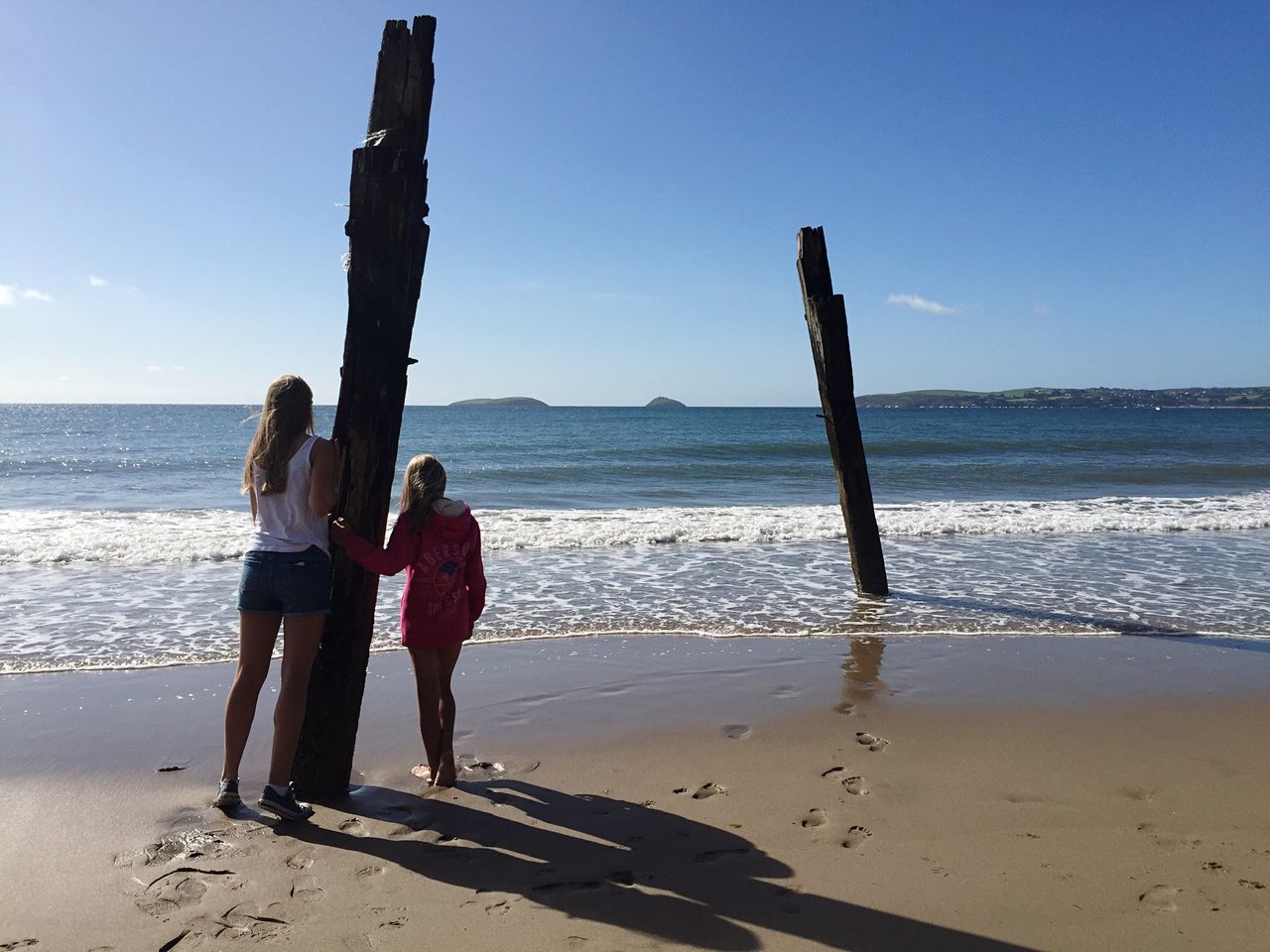 WOMAN WALKING ON BEACH