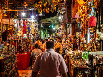 Rear view of people at market stall